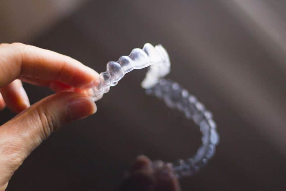 hand holding clear aligner