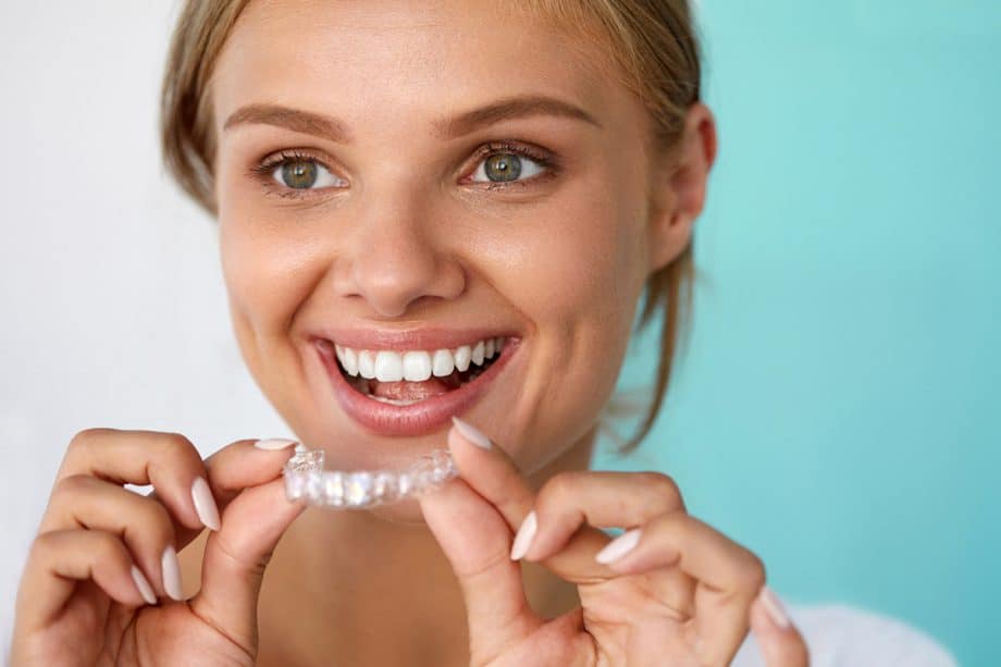 smiling woman with invisalign tray