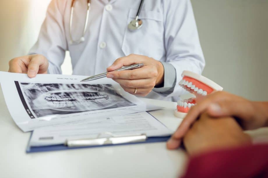 dentist showing x-rays to patient